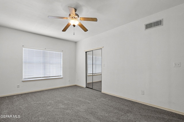 empty room featuring carpet floors and ceiling fan