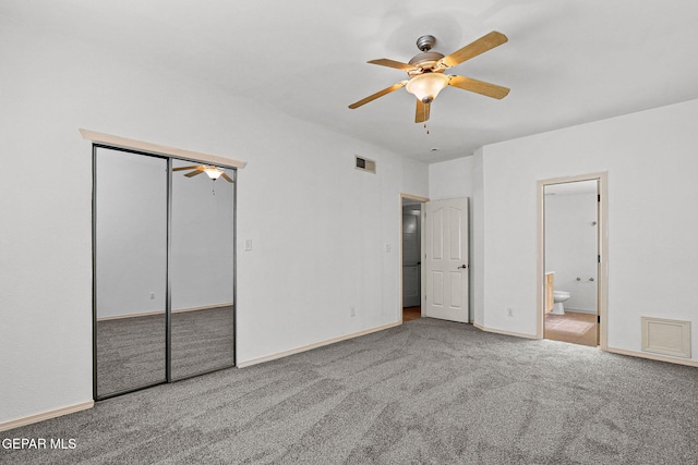 unfurnished bedroom with a closet, ceiling fan, connected bathroom, and carpet flooring