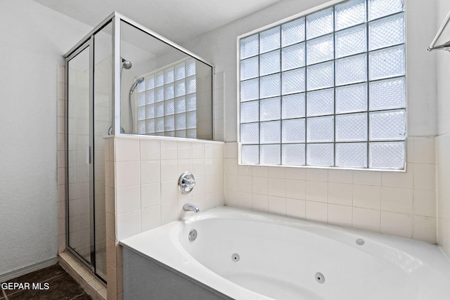 bathroom with separate shower and tub