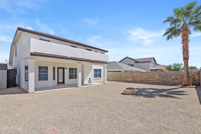 view of front of house with a patio and an outdoor fire pit