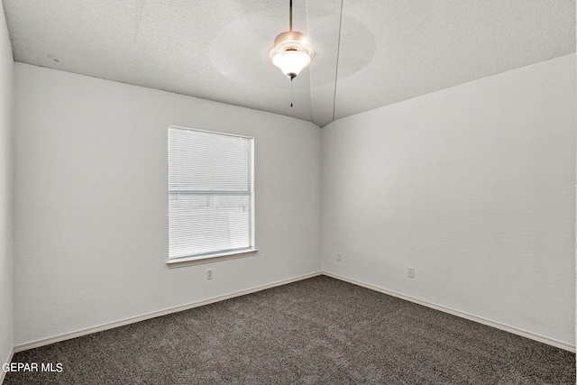 carpeted empty room featuring ceiling fan and a textured ceiling