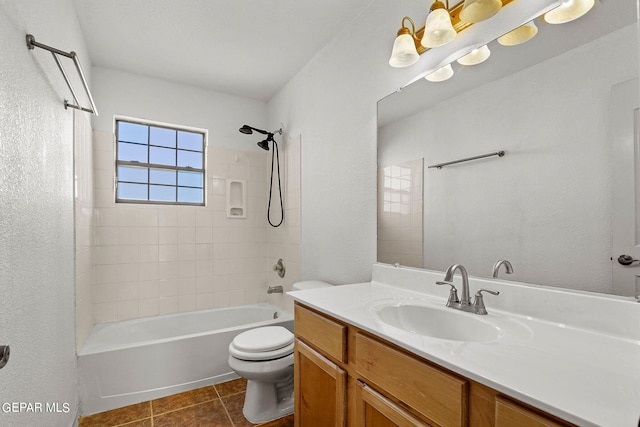 full bathroom with toilet, tiled shower / bath, vanity, and tile patterned floors