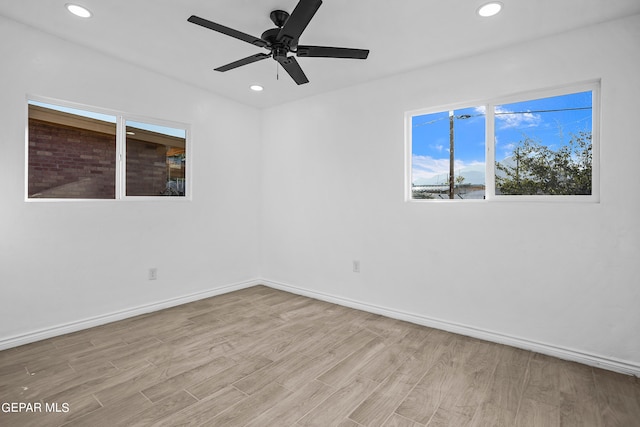 unfurnished room with ceiling fan and light hardwood / wood-style flooring