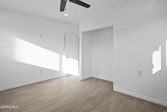 empty room with light hardwood / wood-style floors and ceiling fan