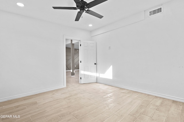 spare room featuring light wood-type flooring and ceiling fan