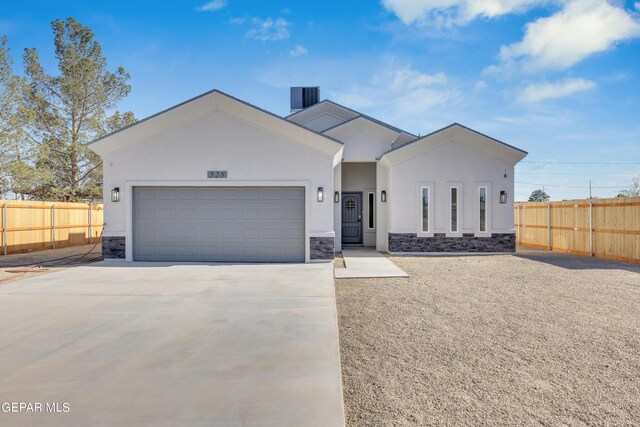 528 Telop Rd, Socorro, TX 79927 - ranch-style house featuring stone siding, a garage, fence, stucco siding, and driveway