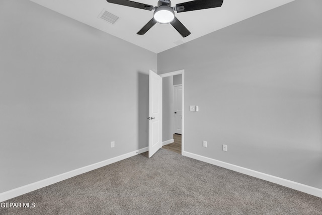 carpeted empty room featuring ceiling fan and lofted ceiling