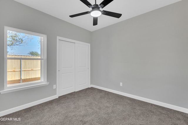 unfurnished bedroom featuring ceiling fan, carpet floors, and a closet