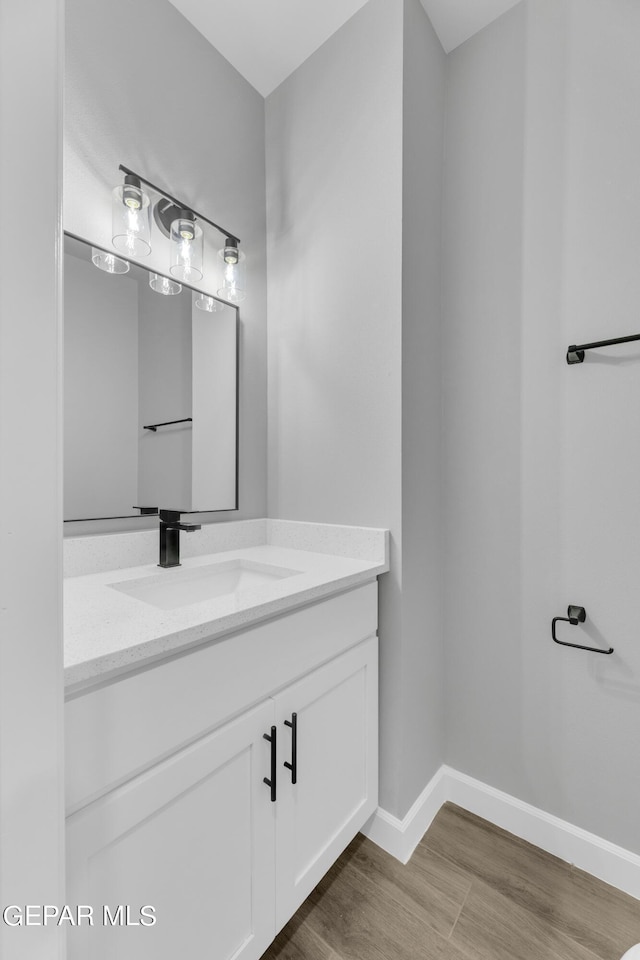 528 Telop Rd, Socorro, TX 79927 - bathroom featuring vanity, baseboards, and wood finished floors