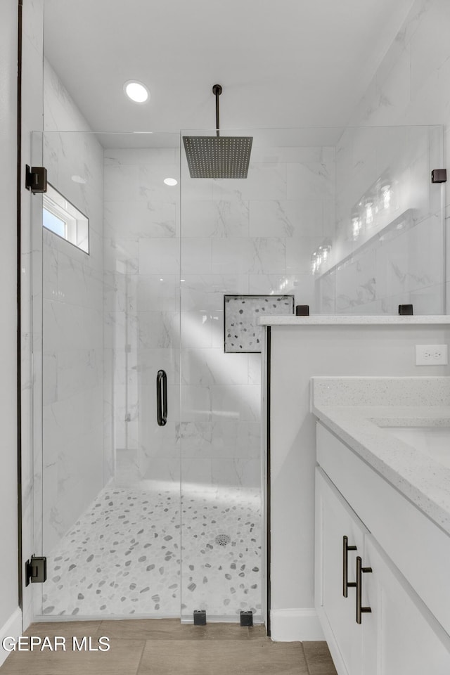 528 Telop Rd, Socorro, TX 79927 - full bathroom with a marble finish shower, recessed lighting, vanity, and wood finished floors