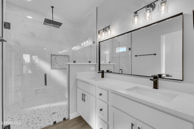 bathroom featuring vanity, hardwood / wood-style floors, and a shower with door