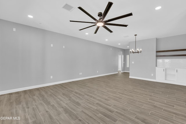 528 Telop Rd, Socorro, TX 79927 - unfurnished living room featuring recessed lighting, light wood finished floors, visible vents, and ceiling fan with notable chandelier