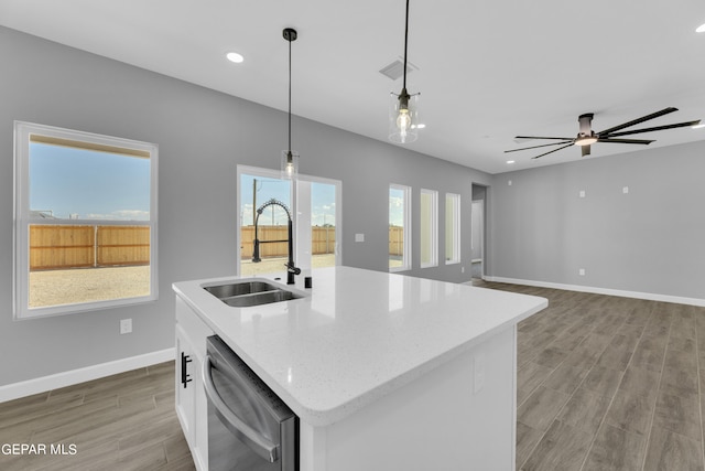 kitchen with pendant lighting, dishwasher, sink, and a wealth of natural light