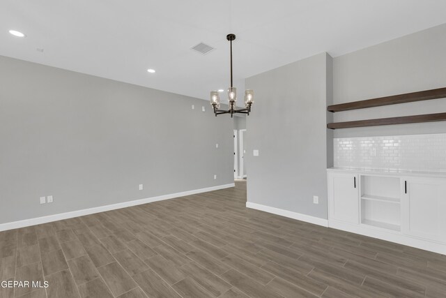 528 Telop Rd, Socorro, TX 79927 - spare room featuring visible vents, baseboards, an inviting chandelier, recessed lighting, and wood finished floors