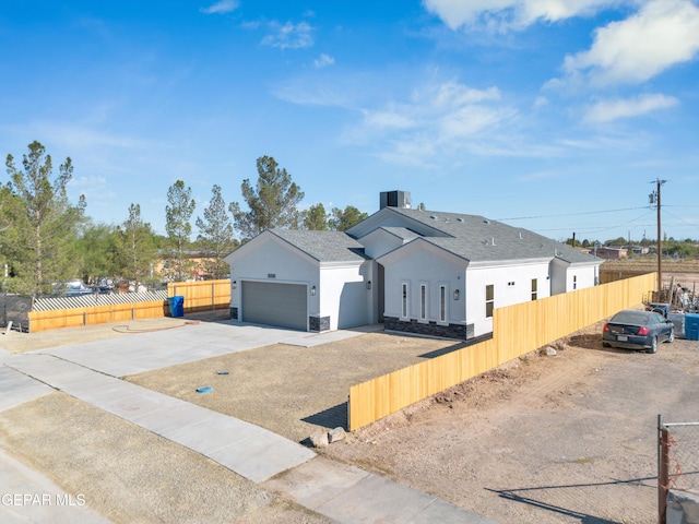 528 Telop Rd, Socorro, TX 79927 - view of front of house with a fenced front yard, stucco siding, concrete driveway, and a garage