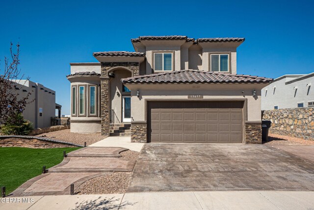 mediterranean / spanish house with a garage