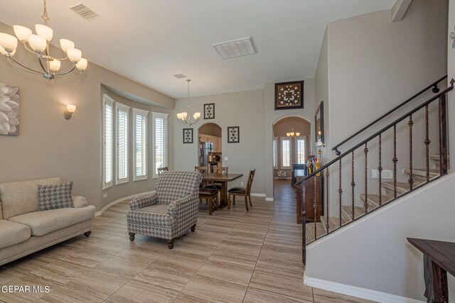 living room with plenty of natural light and an inviting chandelier