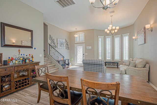 dining space featuring light wood-type flooring and a chandelier