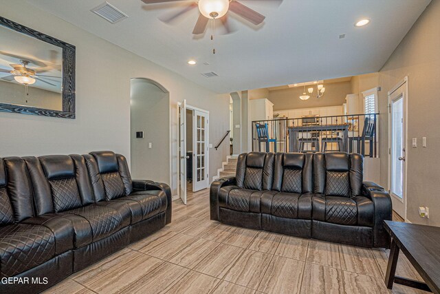 living room with french doors, ceiling fan with notable chandelier, and a wealth of natural light