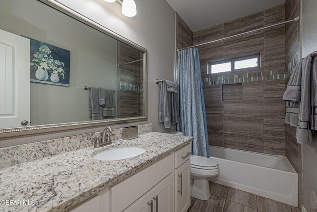 full bathroom featuring shower / tub combo with curtain, vanity, and toilet