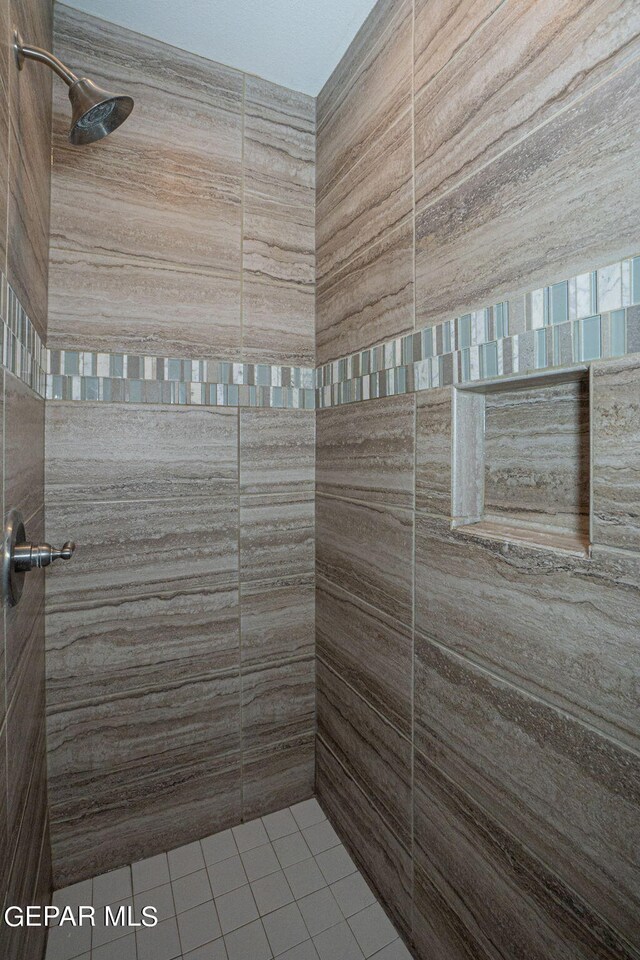 bathroom with a tile shower