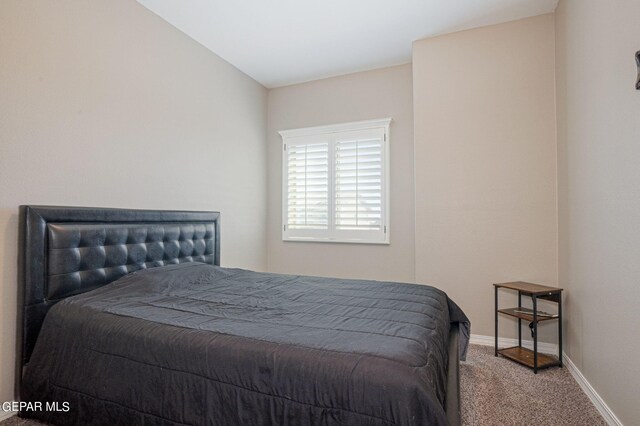 bedroom with carpet floors and vaulted ceiling