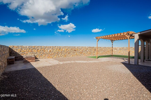 view of yard with a pergola and a patio area