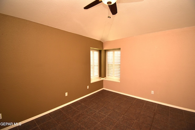 empty room with lofted ceiling, a textured ceiling, and ceiling fan