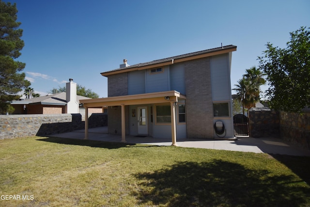 rear view of property featuring a yard and a patio