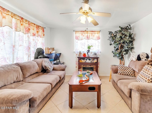 living room with ceiling fan, light tile patterned floors, and a fireplace