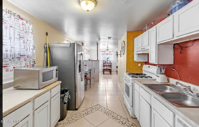 kitchen featuring sink, white cabinetry, white appliances, and light tile patterned floors