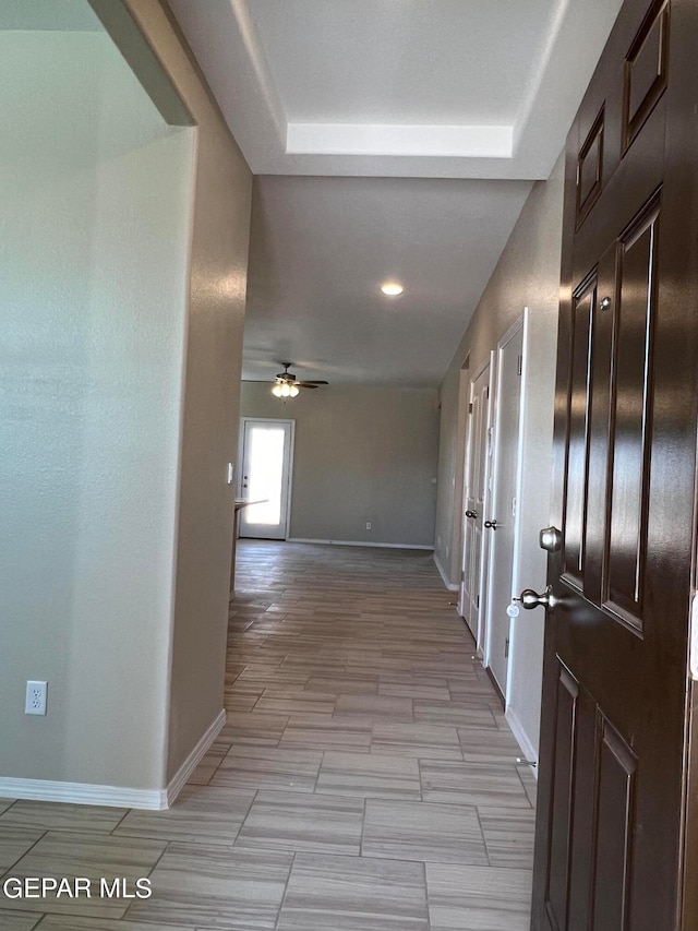 corridor featuring a tray ceiling