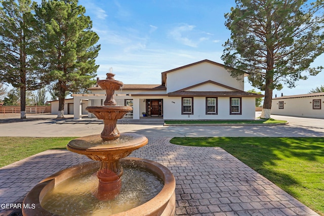 ranch-style house featuring a front lawn