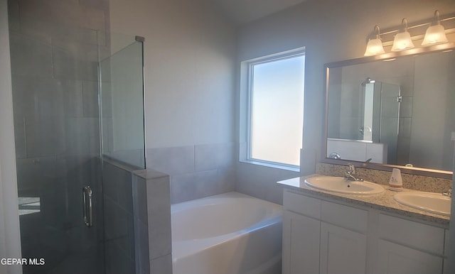 bathroom featuring vanity and plus walk in shower