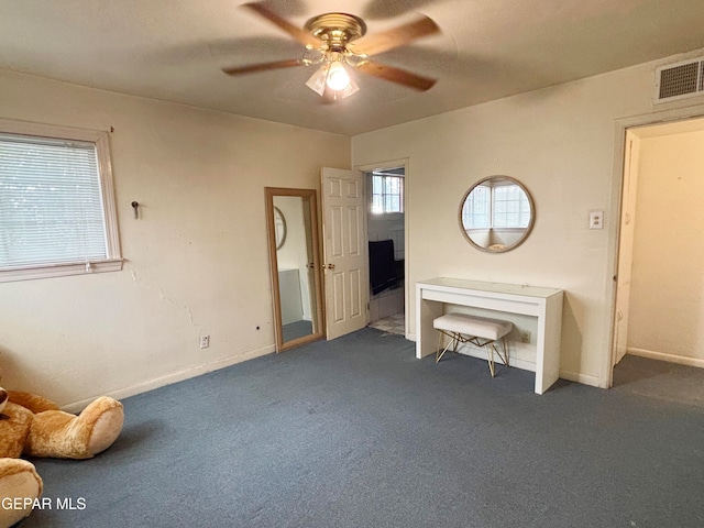 unfurnished bedroom featuring dark carpet and ceiling fan