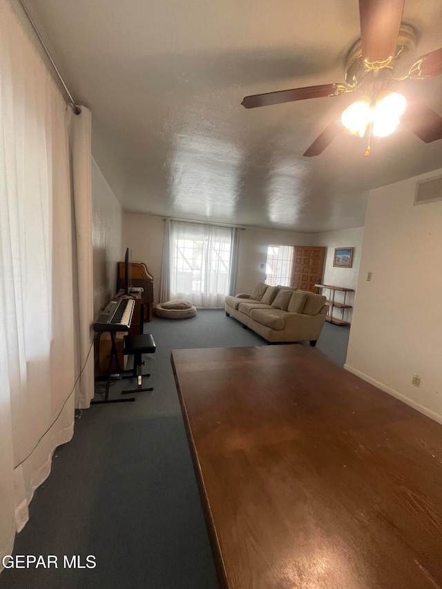 unfurnished living room with ceiling fan