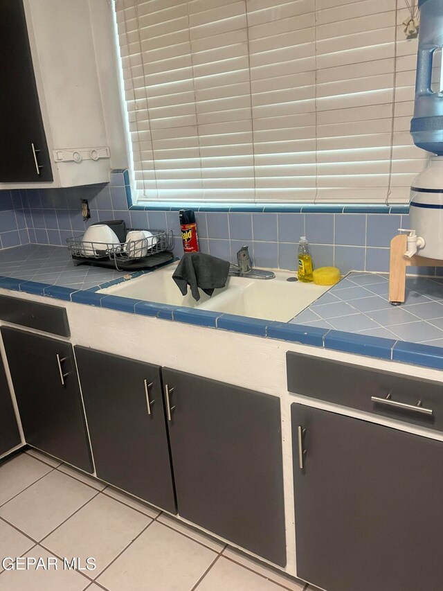 kitchen with decorative backsplash and light tile patterned floors