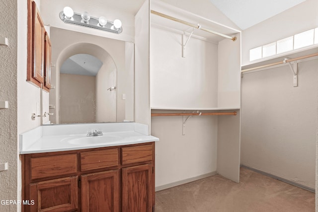 bathroom featuring vanity and vaulted ceiling