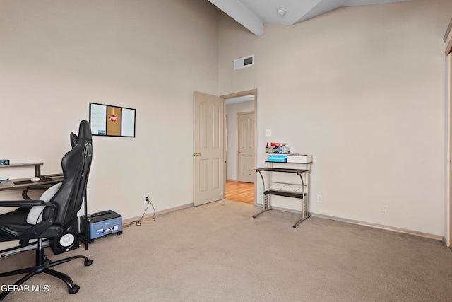 carpeted office space featuring high vaulted ceiling