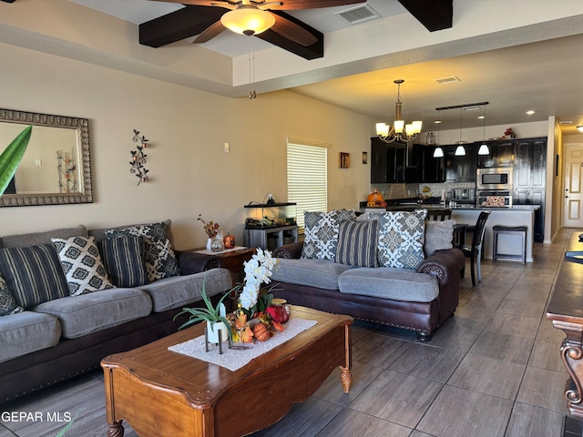 living room featuring ceiling fan with notable chandelier