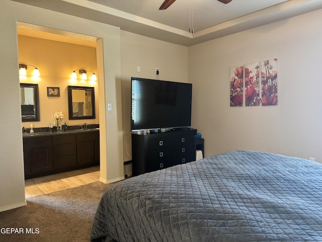 carpeted bedroom with ceiling fan and connected bathroom