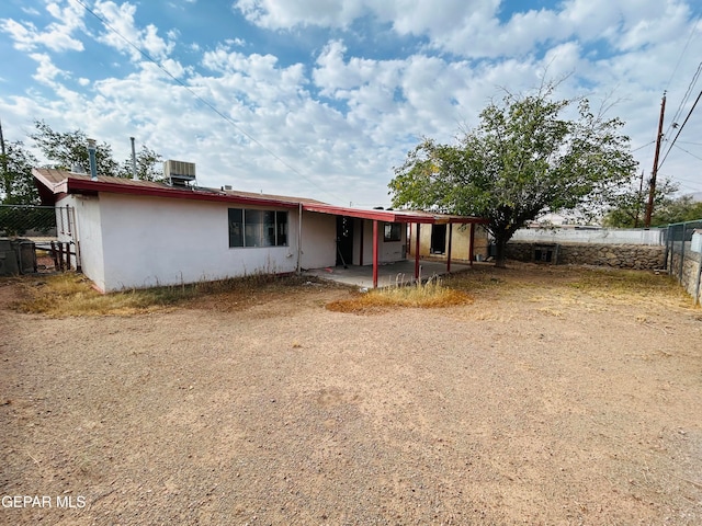 back of house with central AC unit and a patio area