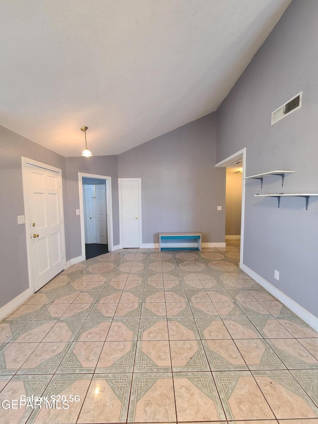 interior space with tile patterned flooring and vaulted ceiling