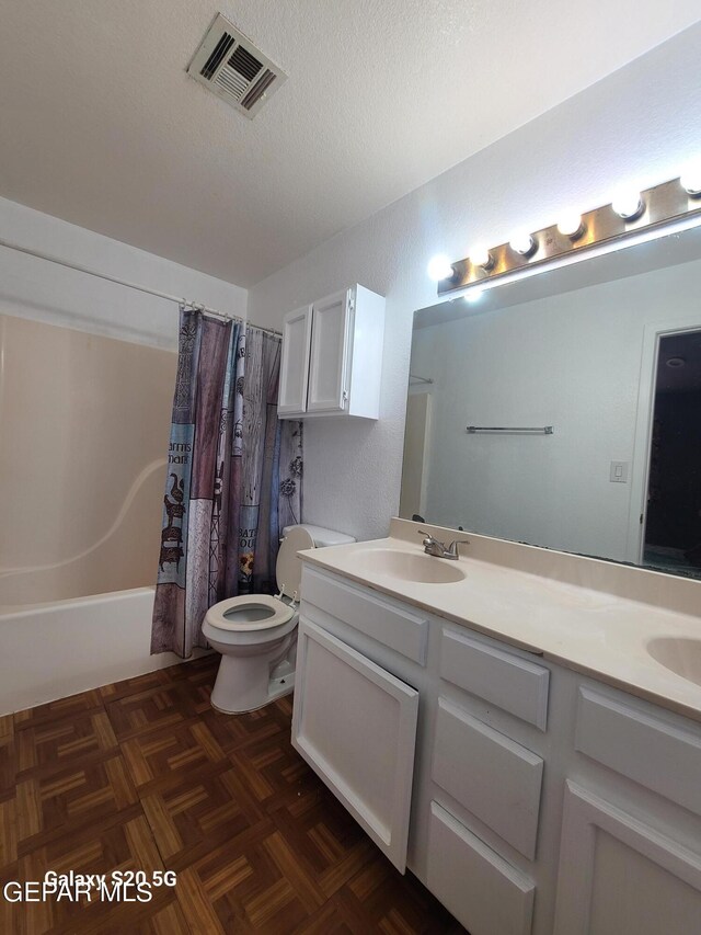 full bathroom featuring shower / bath combo, vanity, parquet floors, toilet, and a textured ceiling