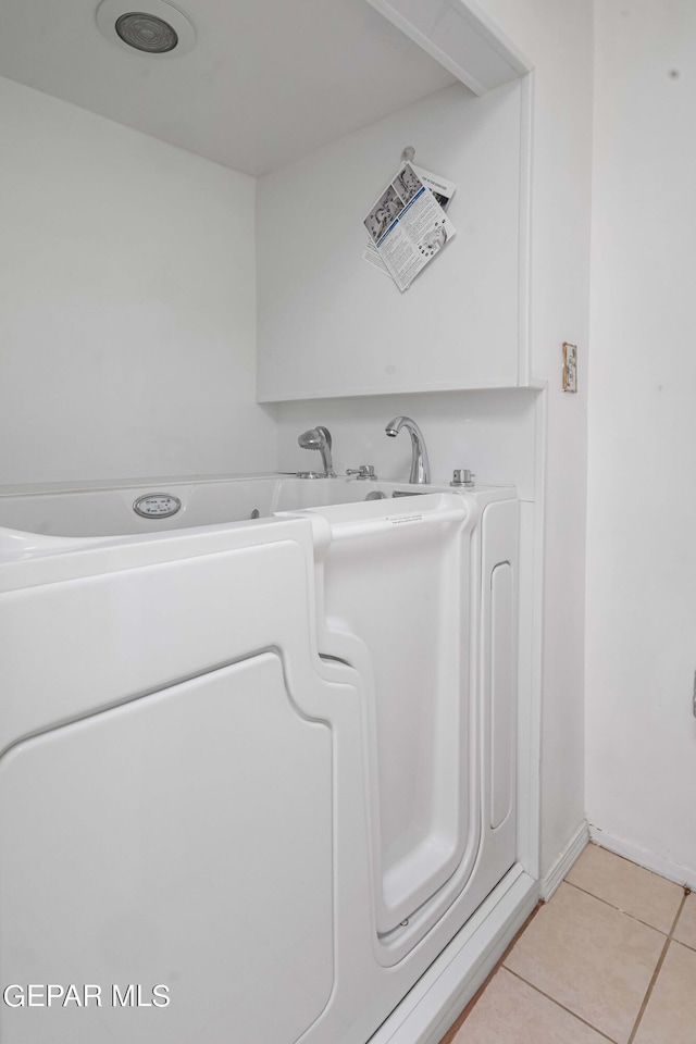 bathroom featuring tile patterned floors and washer / clothes dryer