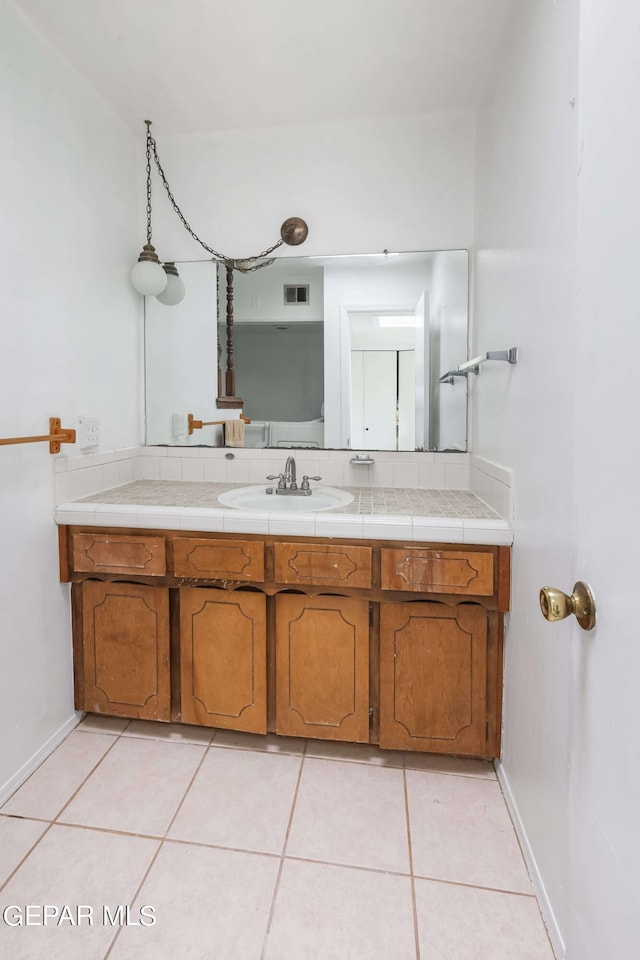 bathroom with tile patterned flooring and vanity