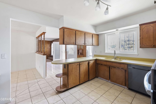 kitchen featuring light tile patterned flooring, sink, kitchen peninsula, and dishwasher