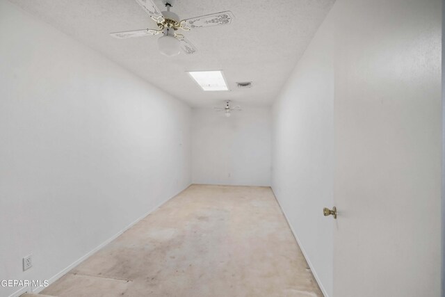 carpeted empty room with a textured ceiling and ceiling fan