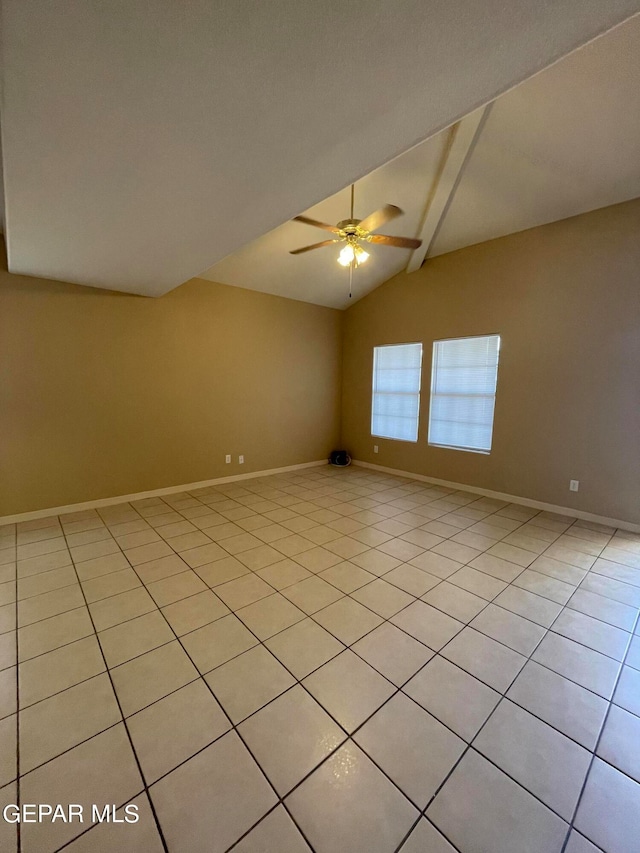 spare room featuring lofted ceiling, light tile patterned floors, and ceiling fan