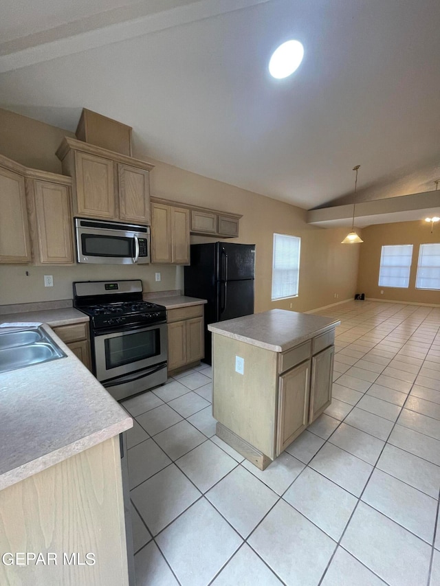 kitchen with a center island, decorative light fixtures, stainless steel appliances, lofted ceiling, and light tile patterned floors